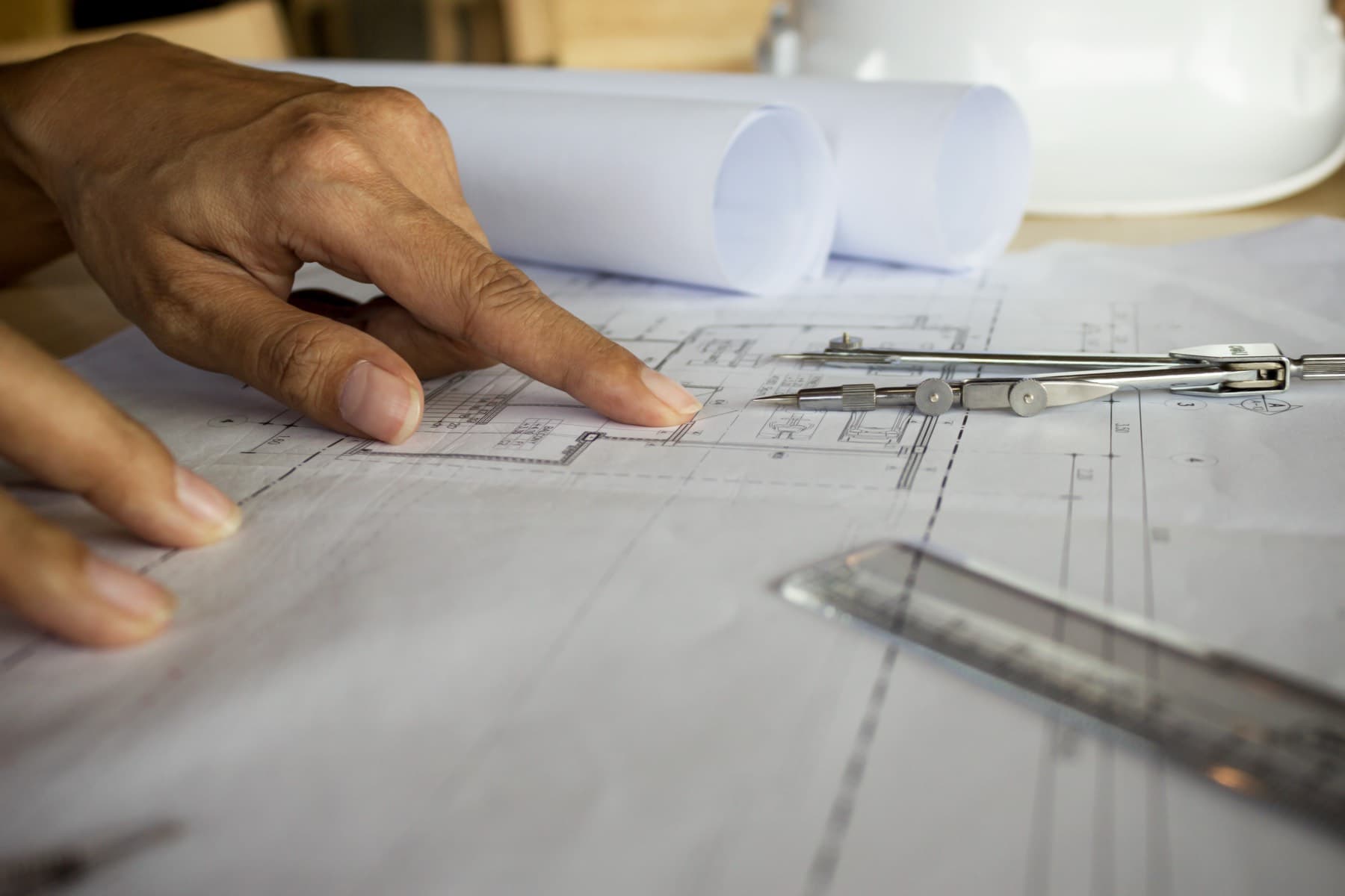 Hands reviewing blueprint drawings